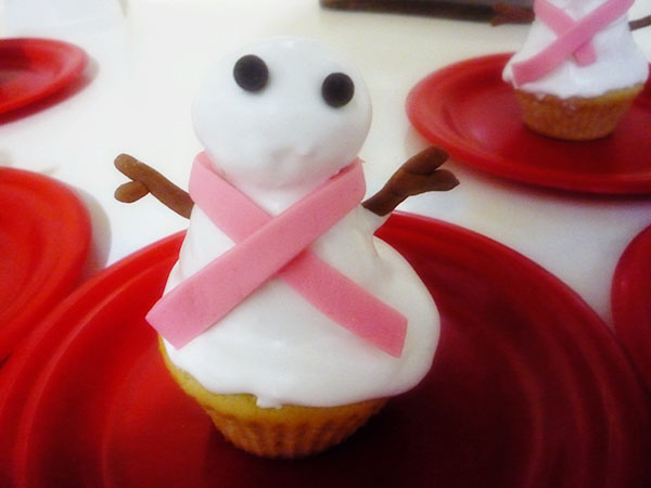 Muñeco de nieve con profiteroles y cupcakes de vainilla ya terminado